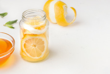 Naklejka na ściany i meble Food useful for immunity. Lemon in honey-sugar syrup on a white background. Copy space