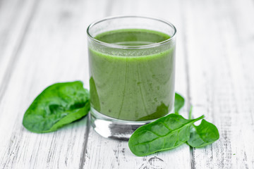 Freshly made spinach smoothie (close up; selective focus)