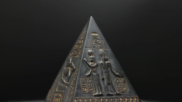 figurine pyramid. pyramid on a black background.