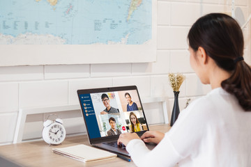 Young Asian businesswoman work at home and virtual video conference meeting with colleagues...