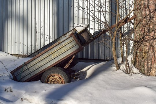 Rusty old cargo trailer in the snow.