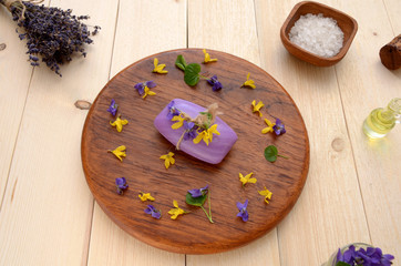 soap with flowers on wooden background