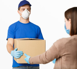 Fototapeta na wymiar Protecting client from epidemic. Courier in mask and gloves