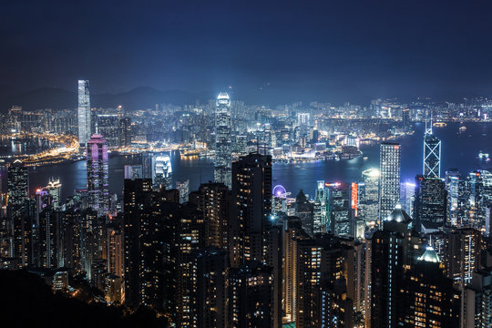 Filtered  aerial night view on Hong Kong - skyscrapers from the  the Peak .  Amazing   illuminated city
