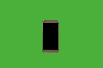 new modern smart phone lying on a green background with a turned off screen. concept of gadgets