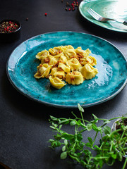 tortellini, pasta with filling (ravioli or dumplings)
second course
Menu concept. food background. top view copy space for text