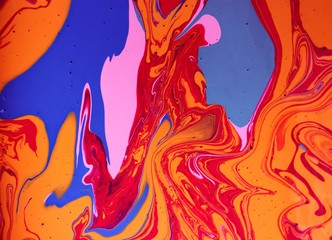 Purple-pink-orange marble abstract background. Acrylic paint flows freely and creates an...