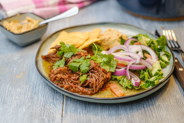Pulled pork on a plate with traditional assessors