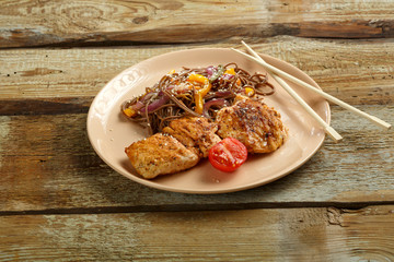 Asian buckwheat soba noodles with vegetables and chicken chop.