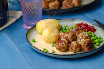 .Swedish meatballs with potatoes on blue wooden table