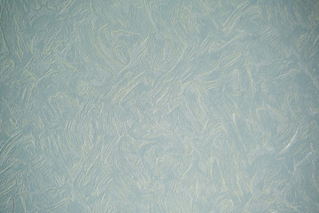 Abstract aquamarine background. A rough concrete wall is covered with cement with an abstract pattern. Organic texture of natural stone.