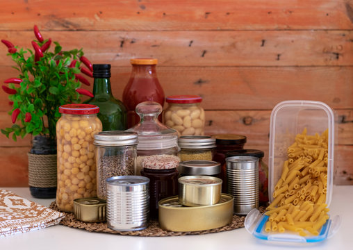 Small storage of canned and preserved non-perishable food useful to a small family quarantined due to coronavirus infection. Stay home to avoid contagion