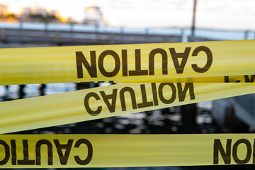 Obraz premium Yellow Caution USA Tape of COVID-19. Coronavirus Outbreak of Quarantine Area, Infection Virus Disease, Risk Area Zone. Biohazard. Lockdown quarantine. Miami Florida Closed. Health Protection Concept.