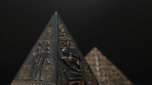 pyramid figure. figurine pyramid on a black background.