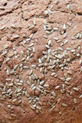 Crust texture of freshly baked bread with seeds, healthy food, whole grain, organic product