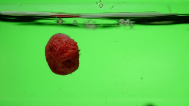 strawberries and blueberries splash in water