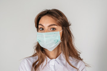 Woman wearing medical mask close up portrait on the white background