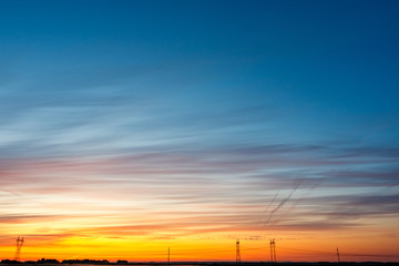 beautiful colored sky over the electric highway which is located on the horizon line