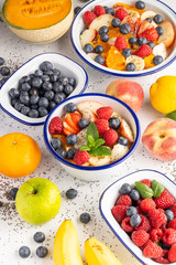 Fresh organic fruit salad with Chia seeds. Healthy breakfast set on grey background. The concept of delicious and healthy food. Top view, copy space