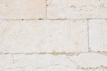 Textur einer Wand aus hellem Naturstein