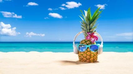 Fotobehang Pineapple with sunglasses and headphones at tropical beach - Holiday Vacation Concept © htpix