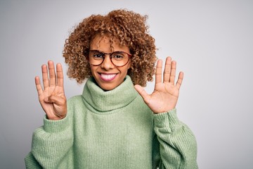 Young beautiful african american woman wearing turtleneck sweater and glasses showing and pointing...
