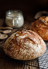 Traditional sourdough loaf of bread  on a  on a cooling tray, close up