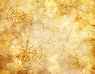 Old compass on paper background