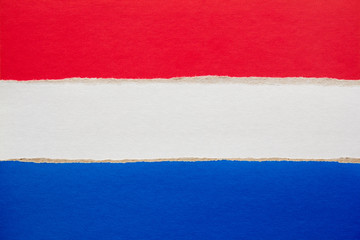 Netherlands national flag made of colored torn paper cardboard.