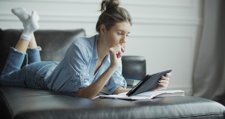 Young woman using digital tablet computer in home