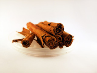 Cinnamon sticks lie on a white background. Real cinnamon, not cassia.
