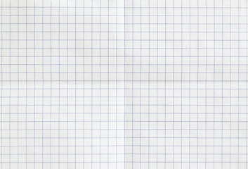 White checkered sheet of exercise book paper folded in two. White crumpled notebook paper texture...