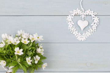 a bouquet of spring flowers and a white openwork heart