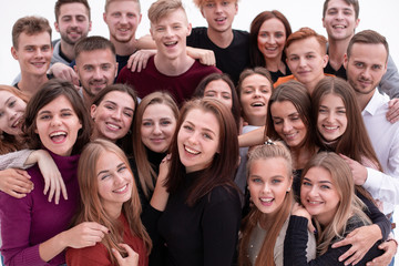 group of confident young people looking at the camera and showing their success