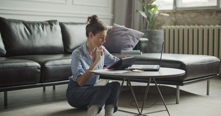 Young woman using digital tablet computer in home