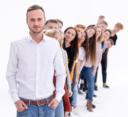 Fototapeta premium confident guy standing first in the column of young people