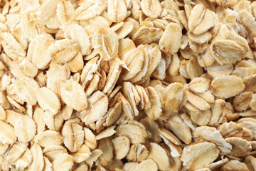 Oatmeal flakes texture on whole background, close up