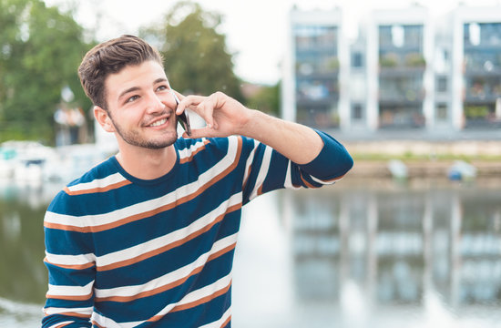 Cheerful  Young Man Talking On The Mobile Phone