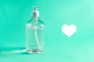 Container with alcohol gel on the light blue background