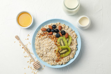 Composition with oatmeal with fruits on white background