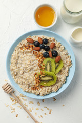 Composition with oatmeal with fruits on white background