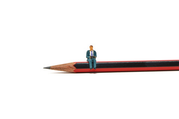 A businessman using a laptop sits on a pencil - Tiny People Working From Home