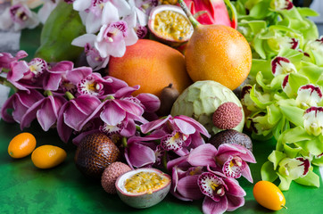 Still life with fresh assorted exotic fruits ans orchids. Concept of healthy eating with fruits.