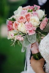 Beautiful and sophisticated wedding bouquet close-up holds the bride in her hands. Wedding bouquet