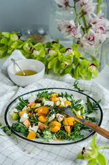 Fresh salad with arugula, mango, papaya, mozzarella, passion fruit and pine nuts.