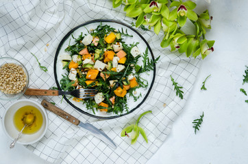Fresh salad with arugula, mango, papaya, mozzarella, passion fruit and pine nuts.