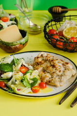 Chicken Salad. Chicken Caesar Salad. Caesar Salad with grilled chicken on plate. Grilled chicken breasts and fresh salad in plate. Lettuce, cherry tomatoes, quail eggs, chicken fillet with parmesan.
