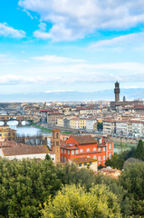 Fototapeta na wymiar Amazing cityscape of Florence, Tuscany, Italy. Historical city center along Arno river with major sights Ponte Vecchio Bridge and Santa Maria Cathedral. Mountains in the background. Vertical photo.