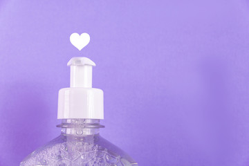 Container with alcohol gel on the light blue background