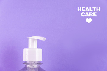 Container with alcohol gel on the light blue background